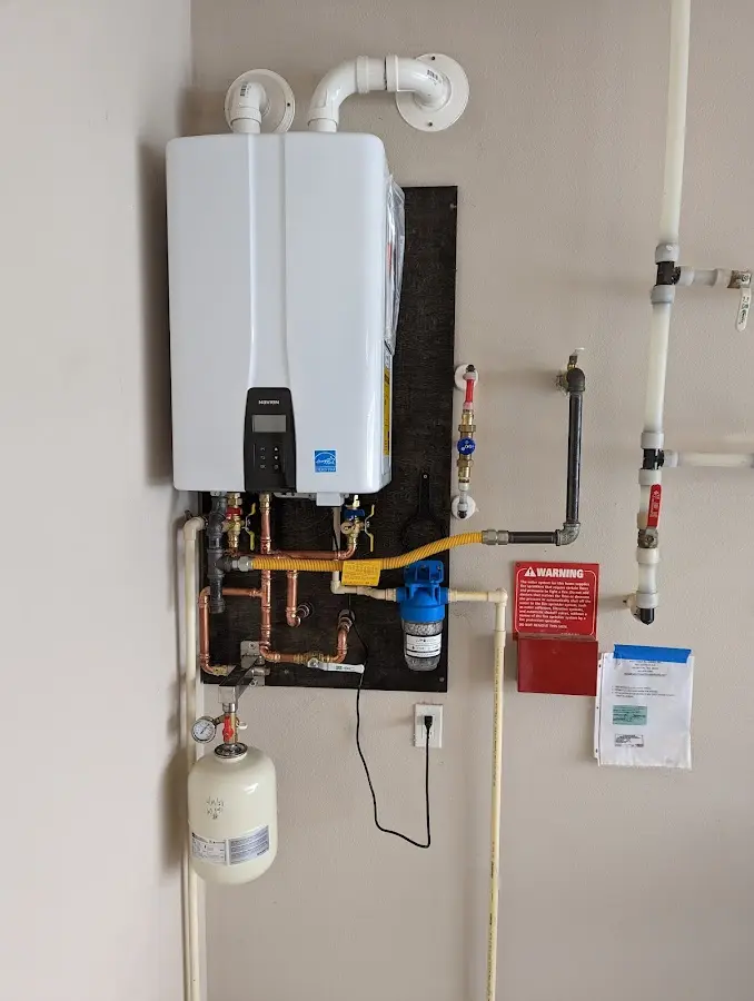 Professional plumber installing copper piping in a White Hall home